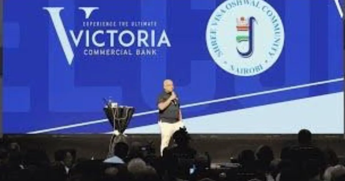 Robin Sharma speaking on stage in front of a Victoria Commercial Bank screen